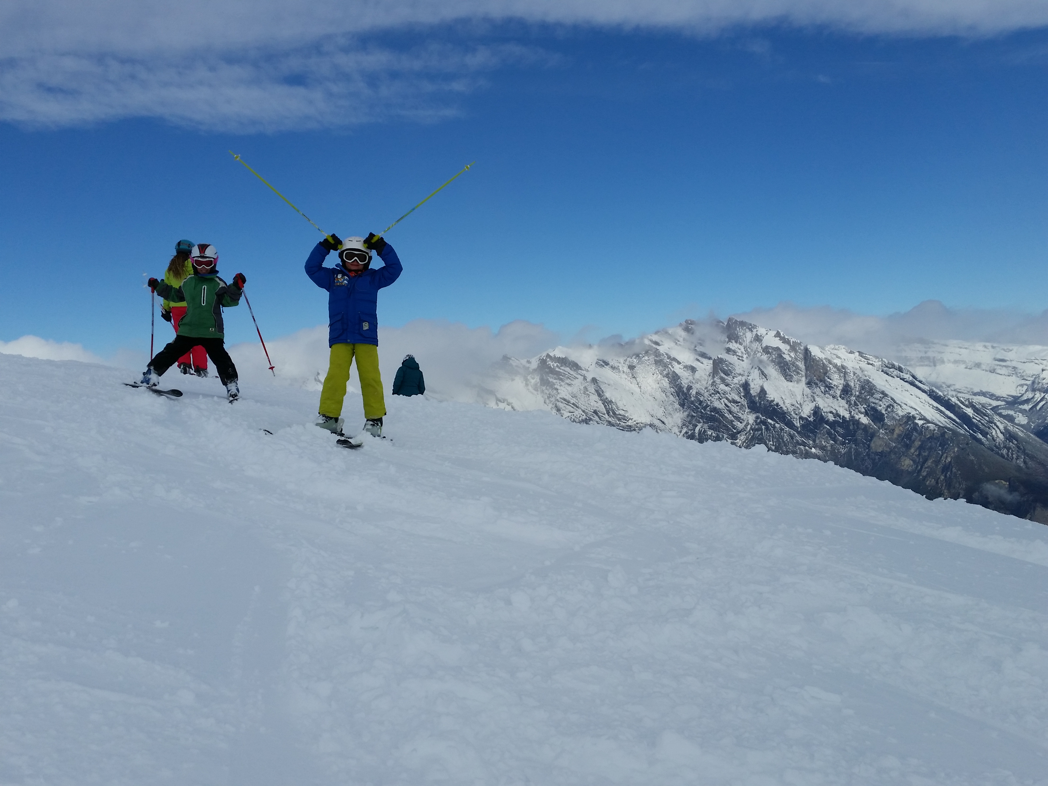 The kids make the most of the fresh snowfall and magnificent blue skies, La Tzoumaz