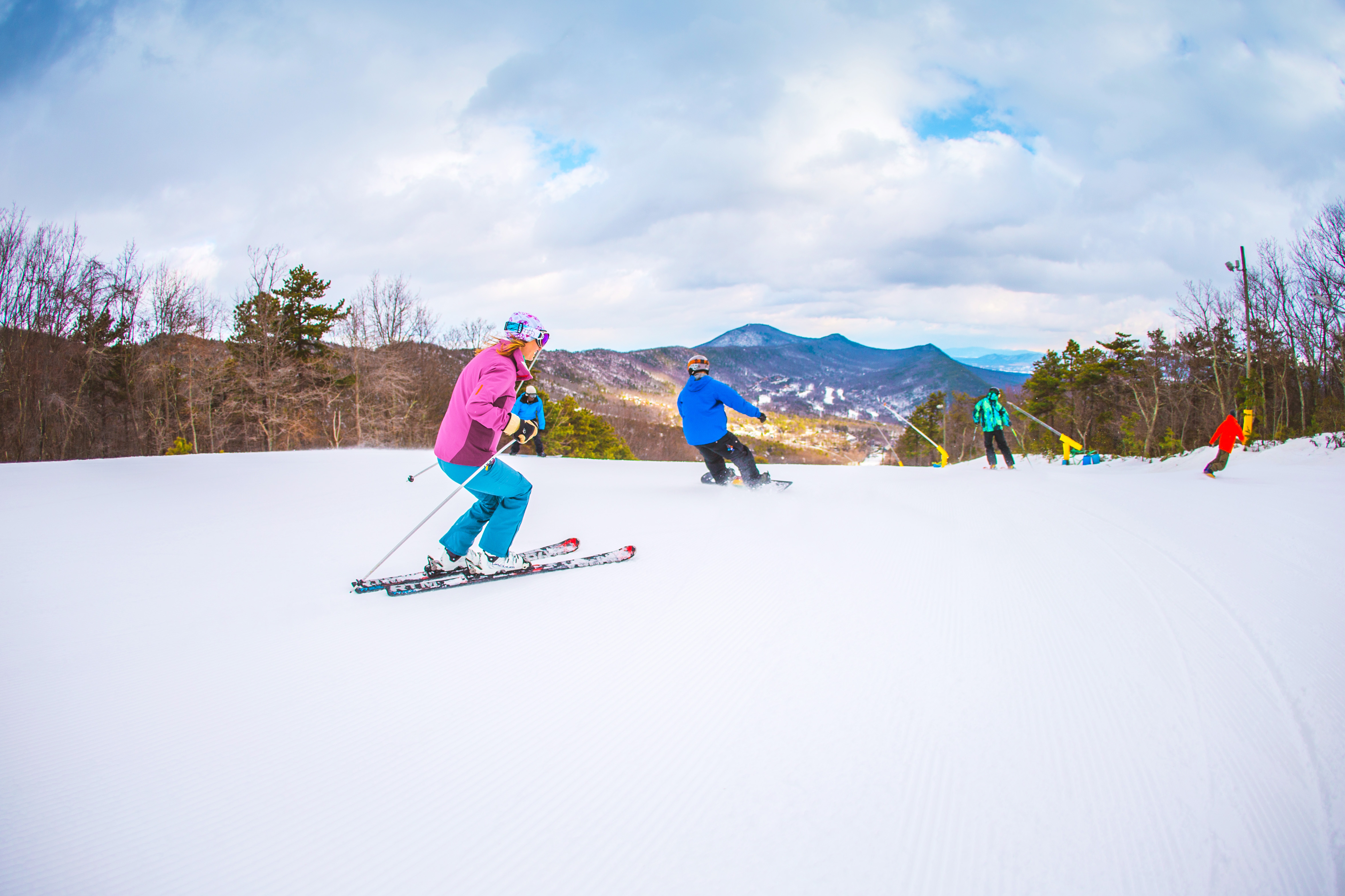 A group skiing and snowboarding at Massanutten Resort