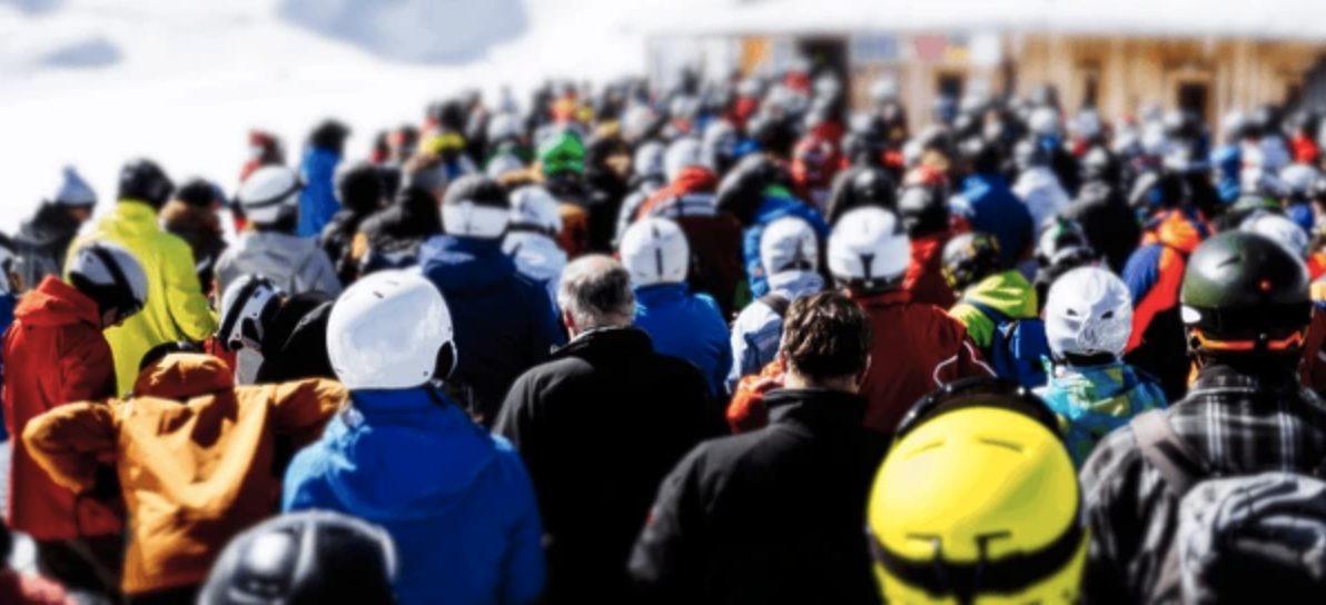 Image: A large crowd of skiers in the queue in front of a ski lift.